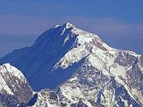 Shishapangma 01 02 Kangchenjunga 01 05 Mountain Flight Shishapangma Close Up Here is a close-up of the summit area of Shishapangma, the 14th highest mountain in the world at 8012m, shining in the early morning sun from Kathmandu�s Mountain flight. The steep and treacherous southwest face is in shadow on the left. The north face is just visible in the sun on the right. The peak to the right of the sloping long sunny ridge in the middle right is Pungpa Ri (7445m), first climbed in 1982. On the far left below Pungpa Ri with its west face in shadow and the east face fully lit is Nyanang Ri (7071m), called the Rock Tooth.